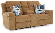 Ashley Furniture Kanlow reclining loveseat with built-in console, shown from an angled view, featuring plush fabric and padded armrests.