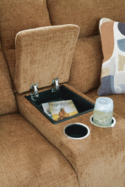 Ashley Furniture Kanlow reclining loveseat with built-in console, showing plush fabric, padded armrests, and reclining feature.