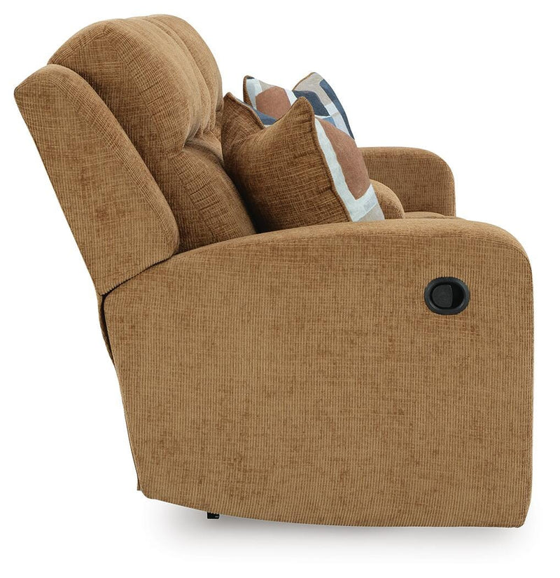 Ashley Furniture Kanlow reclining loveseat with built-in console, featuring plush fabric and padded armrests for comfortable seating.