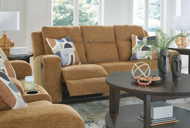 Ashley Furniture Kanlow reclining sofa with plush cushions and wide armrests, shown in a comfortable, modern living room setting.