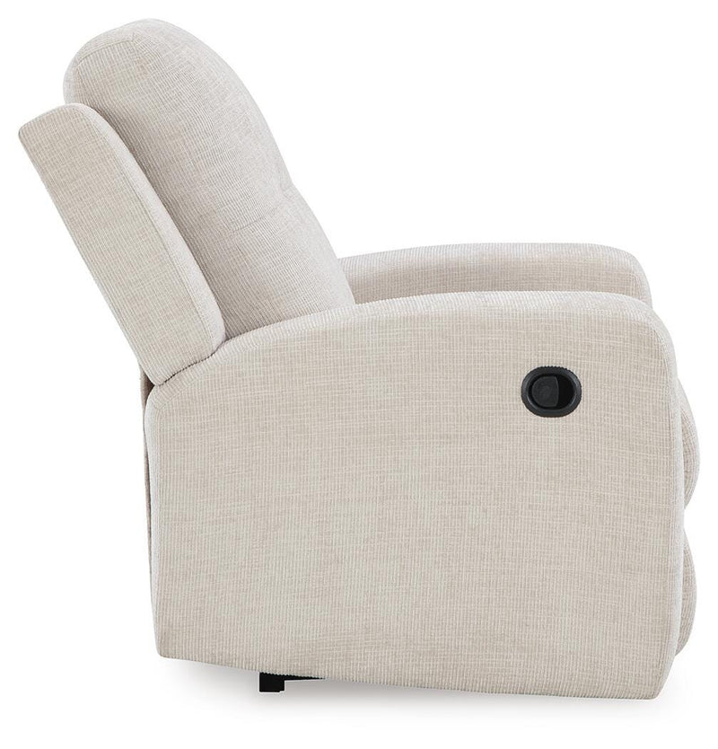Ashley Furniture Danum Recliner with plush cushioning and wooden legs, shown from a side view in a cozy living room setting.