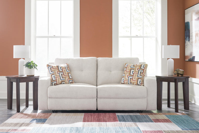 Ashley Furniture Danum Reclining Sofa in dark fabric, showing plush cushions and reclining features in a cozy living room setting.