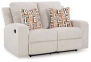 Ashley Furniture Danum reclining loveseat with plush fabric and padded armrests, shown from an angled view.