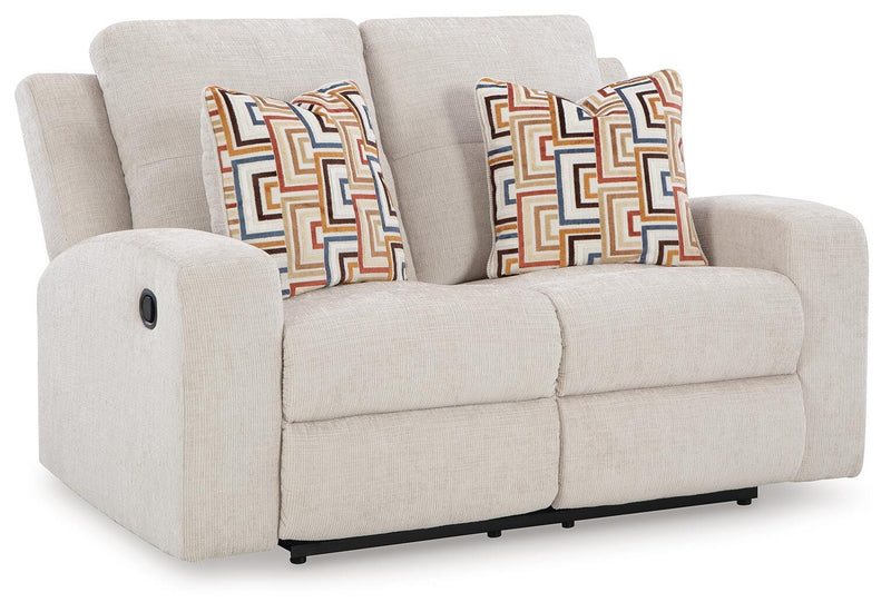 Ashley Furniture Danum reclining loveseat with plush fabric and padded armrests, shown from an angled view.