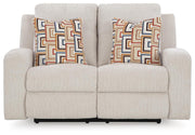Ashley Furniture Danum Reclining Loveseat, shown head-on with plush upholstery and reclining features in a modern living room setting.