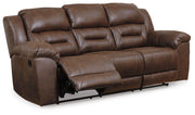 Ashley Furniture Stoneland living room set featuring a sofa and armchair with neutral upholstery and wooden legs.