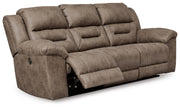 Ashley Furniture Stoneland living room set with sofa and armchair, featuring neutral upholstery and wooden legs.