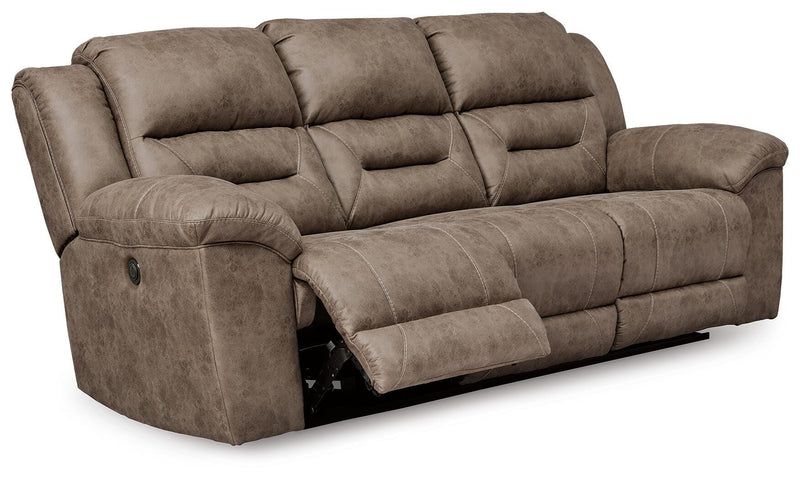 Ashley Furniture Stoneland living room set with sofa and armchair, featuring neutral upholstery and wooden legs.