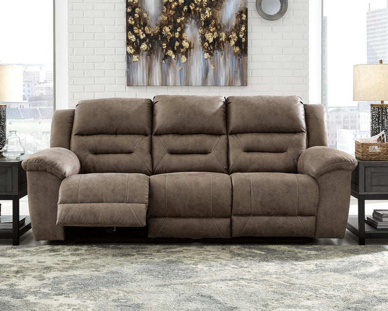 Ashley Furniture Stoneland living room set with sofa and armchair, featuring neutral upholstery and modern design.
