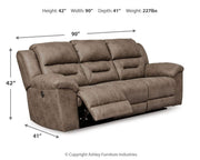 Ashley Furniture Stoneland living room set with sofa and loveseat in a modern fabric, arranged in a stylish living space.