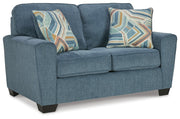 Ashley Furniture Cashton living room set featuring a sectional sofa with plush cushions and modern design in neutral fabric.