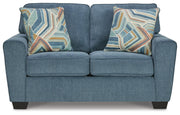 Ashley Furniture Cashton living room set with sofa and loveseat in a modern fabric, shown with plush cushions and wooden legs.