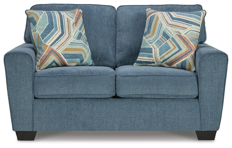 Ashley Furniture Cashton living room set with sofa and loveseat in a modern fabric, shown with plush cushions and wooden legs.