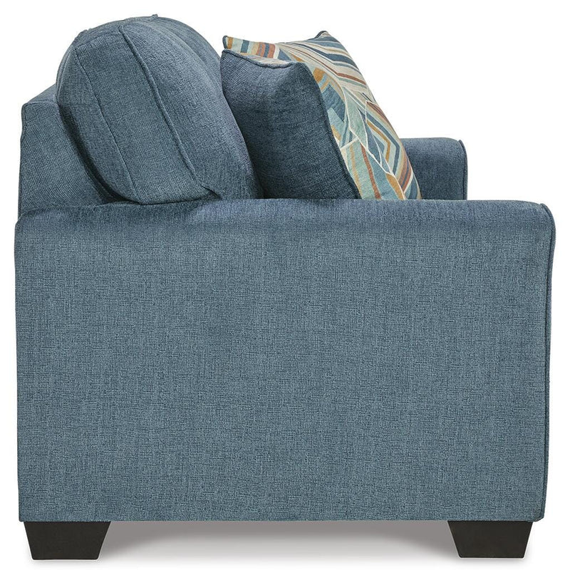 Ashley Furniture Cashton living room set featuring a sofa and loveseat with neutral fabric upholstery and plush cushions.