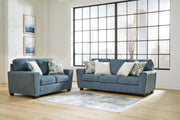 Ashley Furniture Cashton living room set with sofa and armchair, upholstered in neutral fabric, modern design for stylish comfort.