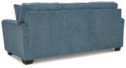 Ashley Furniture Cashton sofa with plush back cushions and soft fabric, shown from the back view.