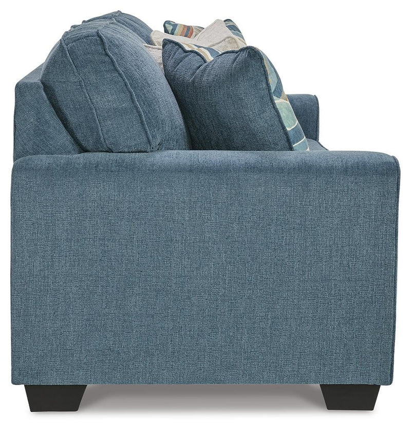 Ashley Furniture Cashton living room set featuring a sofa and loveseat with neutral upholstery and wooden legs.