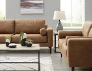 Ashley Furniture Telora living room set with sofa and armchair in a modern design, shown in a cozy, stylish living space.