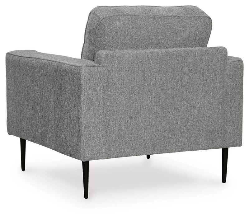 Ashley Furniture Hazela living room set featuring a sofa and armchair with beige upholstery and wooden legs.