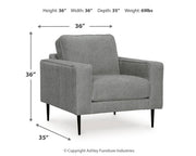 Ashley Furniture Hazela living room set with sofa and loveseat in neutral fabric, modern design, and plush cushions.