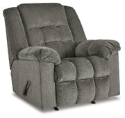 Ashley Furniture Kegler Recliner in dark brown leather with plush cushioning and wide armrests, viewed from an angled closed position.