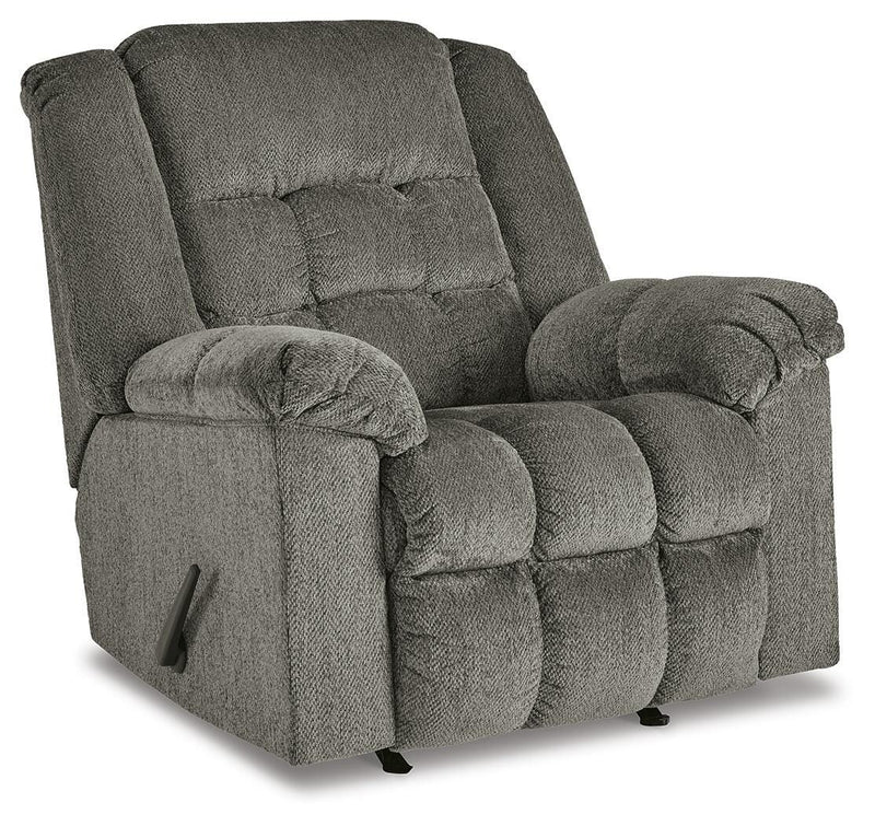 Ashley Furniture Kegler Recliner in dark brown leather with plush cushioning and wide armrests, viewed from an angled closed position.
