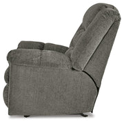 Ashley Furniture Kegler Recliner in brown fabric with padded armrests and plush cushioning, viewed from the side.