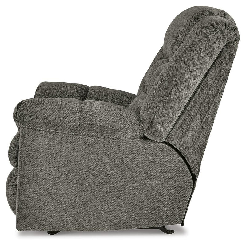 Ashley Furniture Kegler Recliner in brown fabric with padded armrests and plush cushioning, viewed from the side.