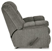 Ashley Furniture Kegler Recliner in beige fabric with plush cushioning and wide armrests, shown from side view.