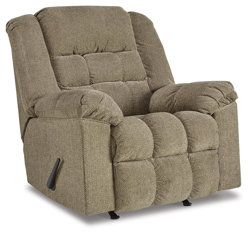 Ashley Furniture Kegler Recliner in dark brown fabric, shown from an angle with closed reclining mechanism and plush cushioning.
