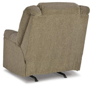 Ashley Furniture Kegler Recliner with plush upholstery and padded armrests, shown from the back in a cozy living room setting.