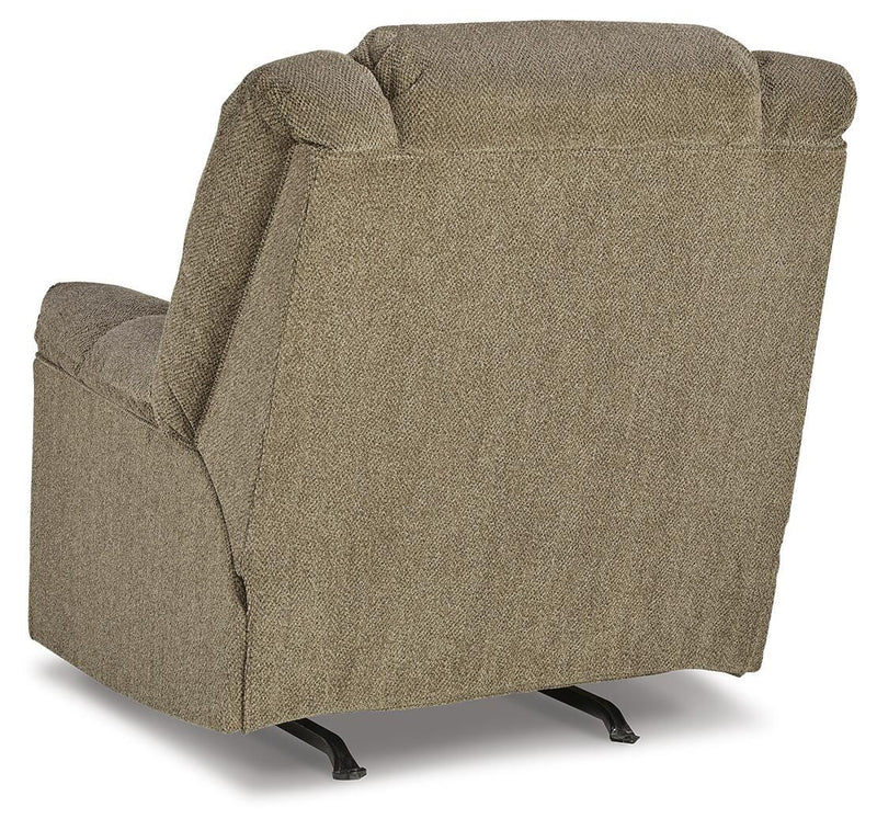 Ashley Furniture Kegler Recliner with plush upholstery and padded armrests, shown from the back in a cozy living room setting.