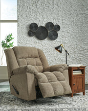 Open view of Ashley Furniture Kegler Recliner showing plush brown upholstery and padded armrests in a comfortable reclined position.