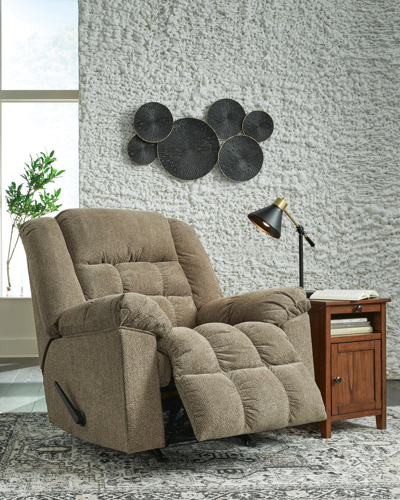Open view of Ashley Furniture Kegler Recliner showing plush brown upholstery and padded armrests in a comfortable reclined position.