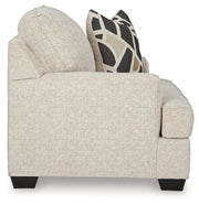 Ashley Furniture Heartcort oversized chair with plush upholstery and wide armrests, shown from the side in a modern living room setting.