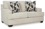 Ashley Furniture Heartcort loveseat with plush fabric and cushioned armrests, shown from an angled side view.