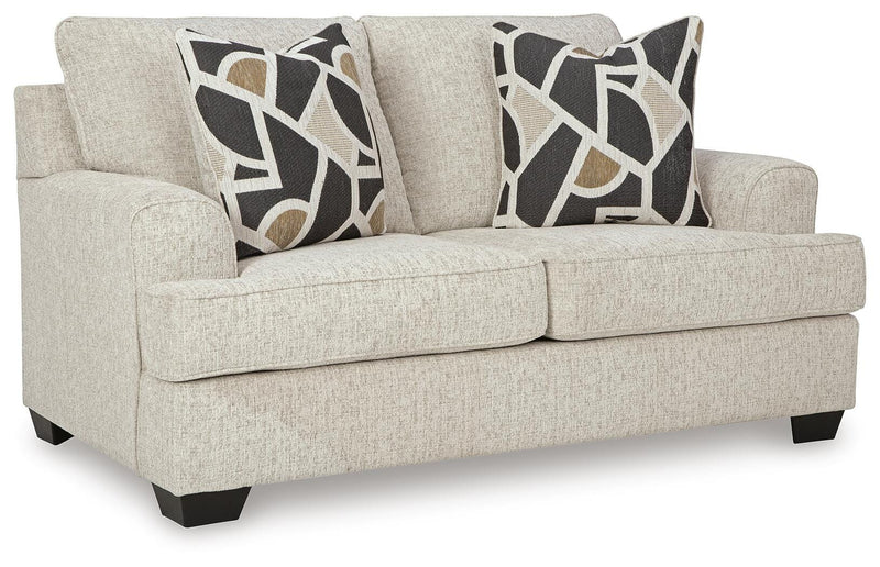 Ashley Furniture Heartcort loveseat with plush fabric and cushioned armrests, shown from an angled side view.