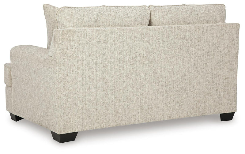 Ashley Furniture Heartcort loveseat with plush fabric, featuring cushioned back and armrests, shown from the back in the image.