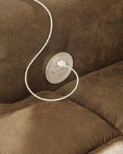 Ashley Furniture Boothbay Power Reclining Sofa with USB ports, showing plush fabric and reclining mechanism in a modern living room setting.