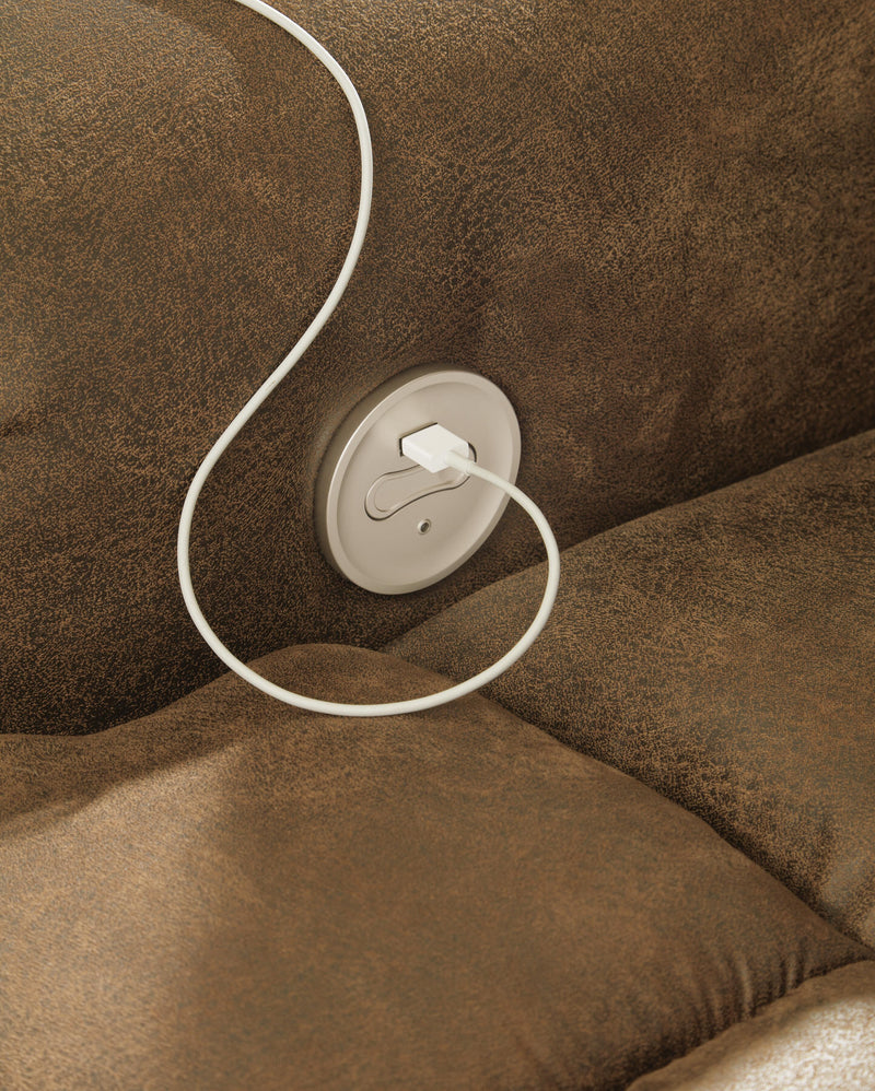 Ashley Furniture Boothbay Power Reclining Sofa with USB ports, showing plush fabric and reclining mechanism in a modern living room setting.