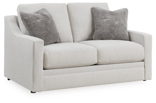 Ashley Furniture Maitelynn loveseat in beige fabric, angled view showing plush cushions and wooden legs.