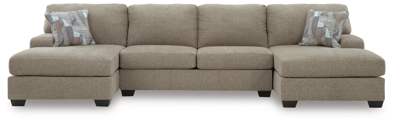 Ashley Furniture Newellen sectional with double chaise, featuring plush fabric and modern design in a spacious living room setting.