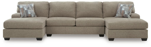 Ashley Furniture Newellen sectional with double chaise, featuring plush fabric and modern design in a spacious living room setting.