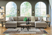 Ashley Furniture Newellen sectional with chaise, showing a modern fabric sofa with plush cushions and a spacious chaise lounge.