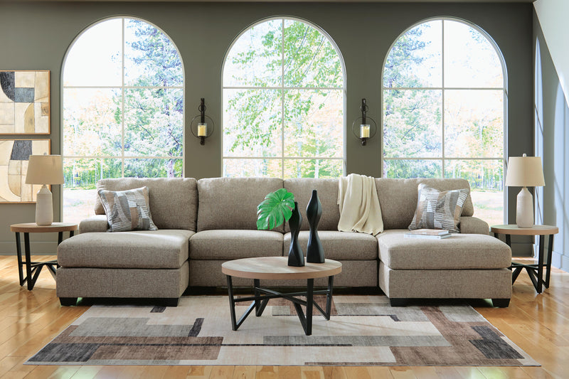 Ashley Furniture Newellen sectional with chaise, showing a modern fabric sofa with plush cushions and a spacious chaise lounge.