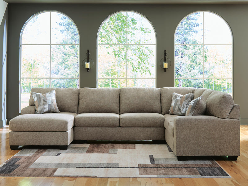 Ashley Furniture Newellen sleeper sectional with chaise, featuring plush cushions and a modern design in a cozy living room setting.
