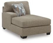 Ashley Furniture Newellen sectional with double chaise, showing a stylish L-shaped fabric sofa with plush cushions and modern design.