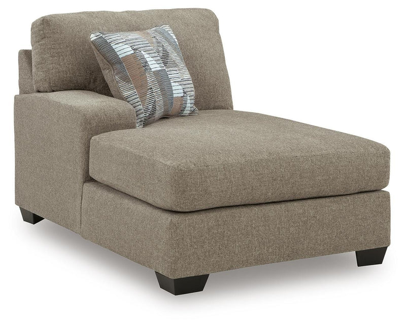 Ashley Furniture Newellen sectional with double chaise, showing a stylish L-shaped fabric sofa with plush cushions and modern design.