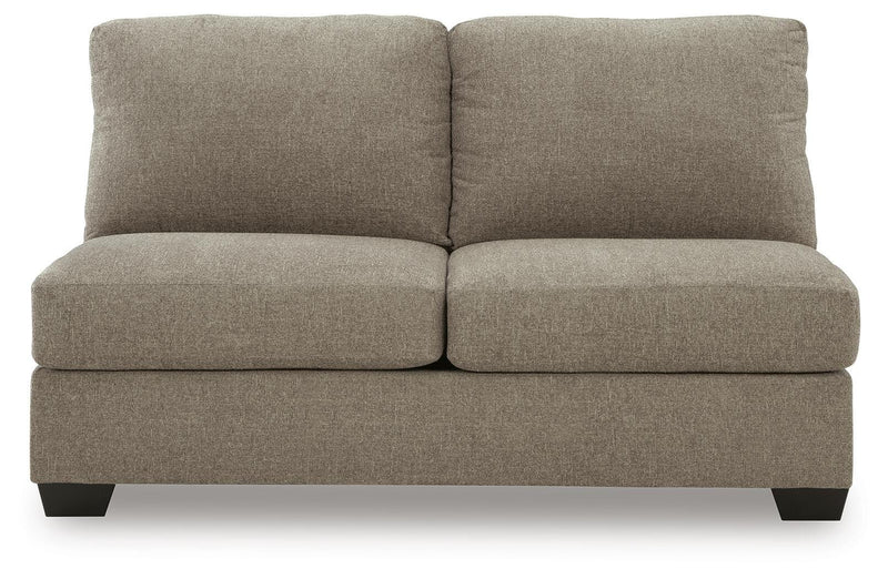 Ashley Furniture Newellen sectional with chaise, showing the modern fabric sectional sofa with plush cushions and wide chaise lounge.
