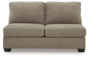 Ashley Furniture Newellen Sleeper Sectional with Chaise, featuring plush upholstery and a modern design, shown from a head-on view.